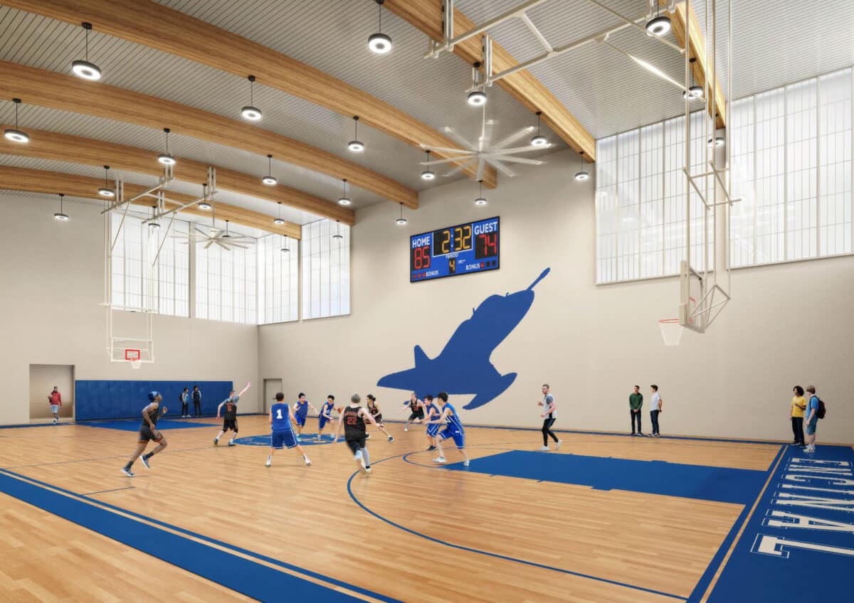 Alameda Post - a render of the inside of a basketball court in a gym. On the walls are large window-like facades that let in some light but are not completely see through.