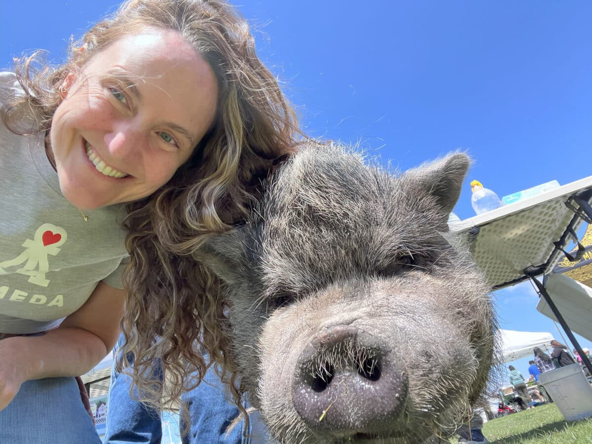 Alameda Post - a woman takes a selfie with a pig