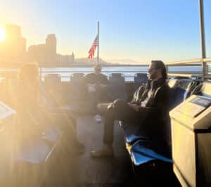 Alameda Post - two passengers ride the ferry on the top deck with the sunset in the background, presumably on the way home to Alameda from San Fransisco