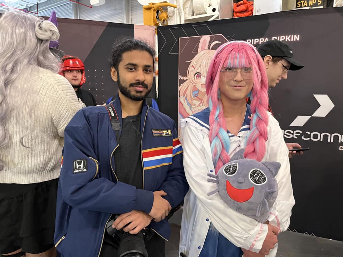 Alameda Post - two guests at Carrier Con, one of whom is in a cosplay costume, smile while in line to see a VFleet character