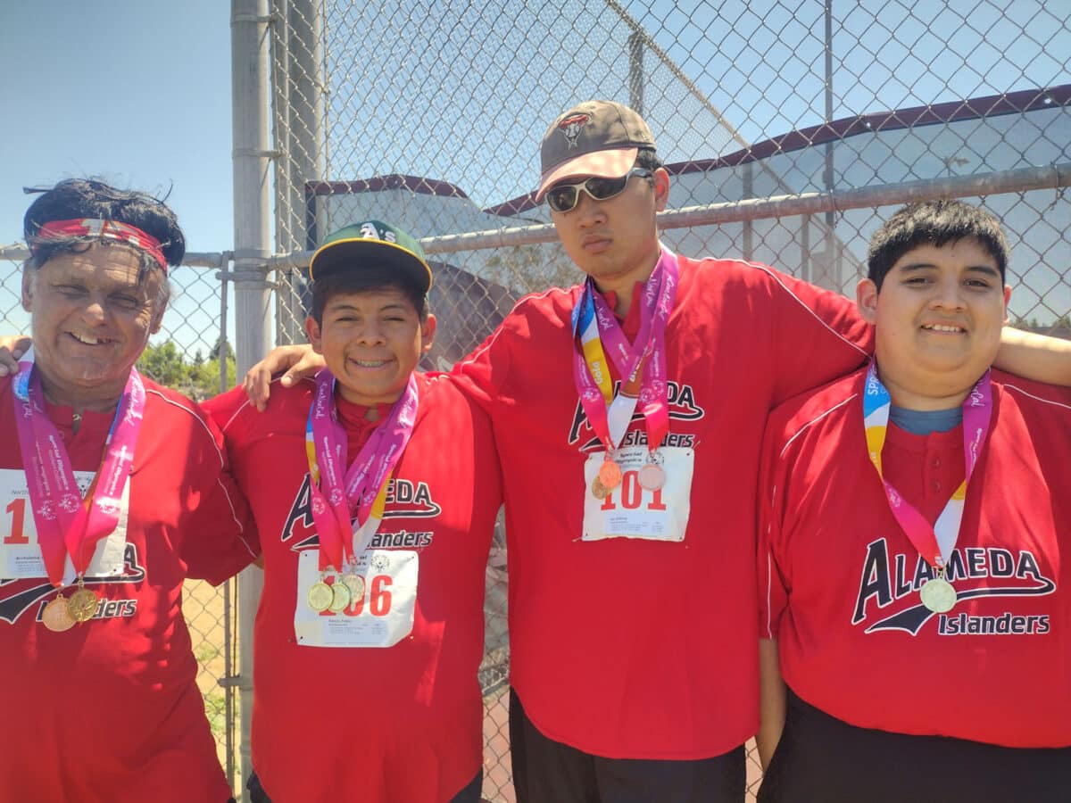 Alameda Post - four men pose together for a photo with medals around their necks