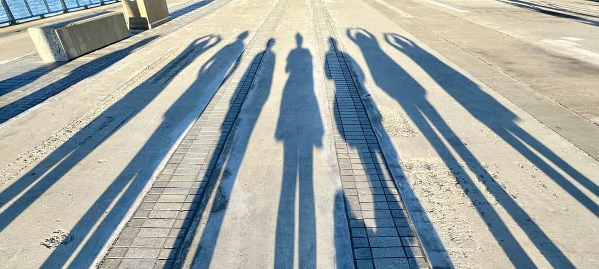 Alameda Post - the shadows of seven people stretch out in front of the camera