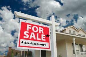 Alameda Post - a sign in front of a home that says "For Sale" with a note that says "See disclosure"