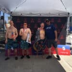 Alameda Post - three swimmers stand with one coach or mentor