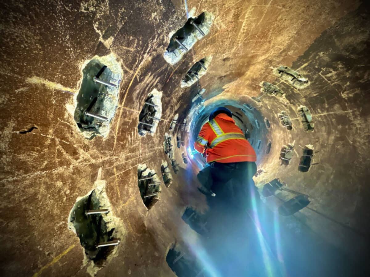 Alameda Post - an EBMUD worker crawls inside a large pipe