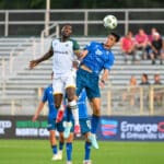 Alameda Post - an Oakland Roots and North Carolina FC jump into the air trying to head the ball