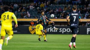Alameda Post - an Oakland Roots player jumps for the ball in a match against New Mexico United