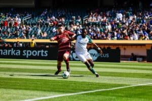 Alameda Post - an Oakland Roots and Sacramento Republic player both try to get control of the ball