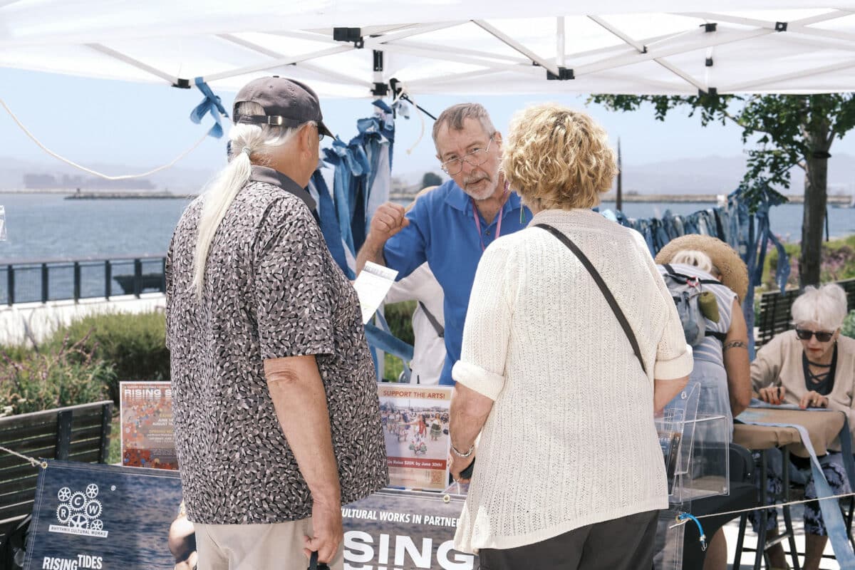 Alameda Post - attendees at Rising Seas visit a booth