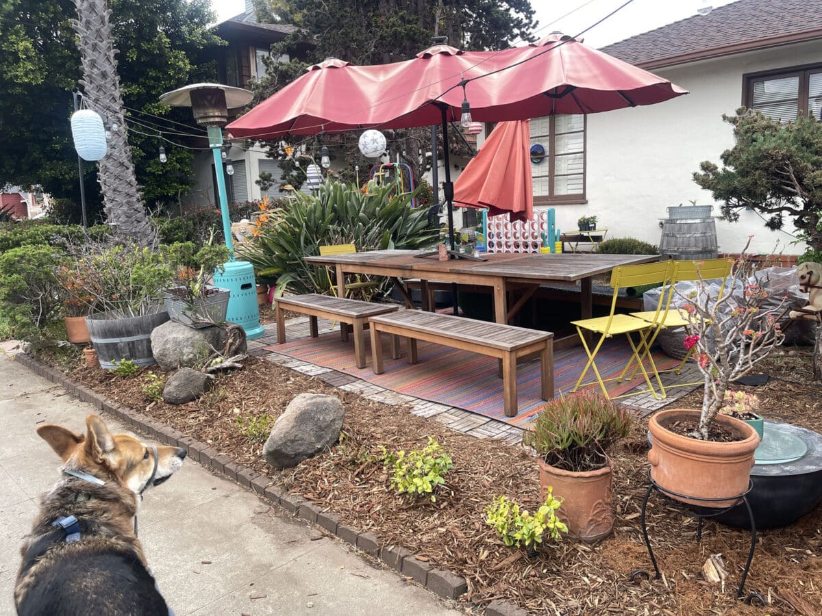 Alameda Post - a dining area in a yard with picnic tables and decor