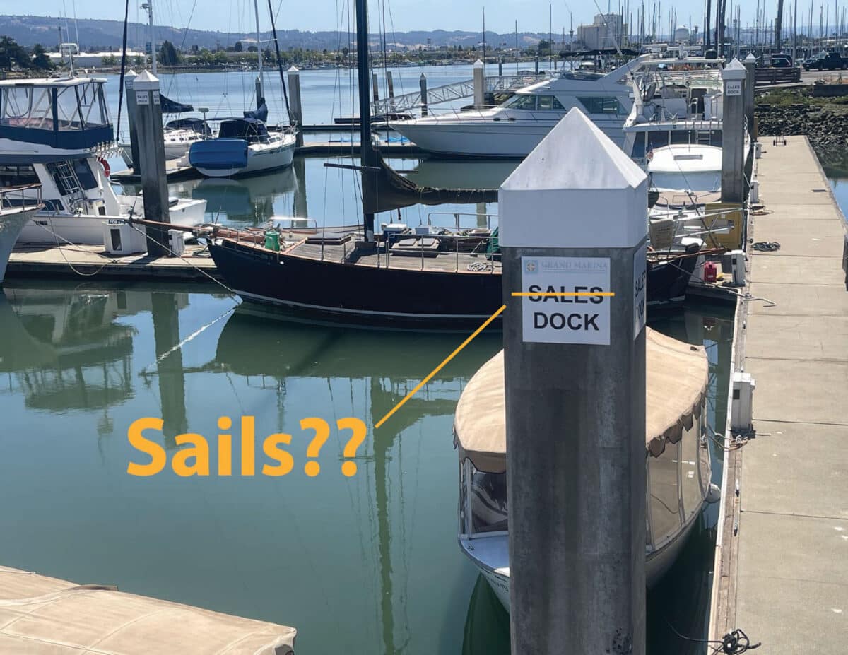 Alameda Post - a photo of a sign at a marina that says "Sales Dock" for boats that are for sale. A funny edit has been made to the photo where "sale" has been crossed off and the other spelling of the word has been added with a question mark