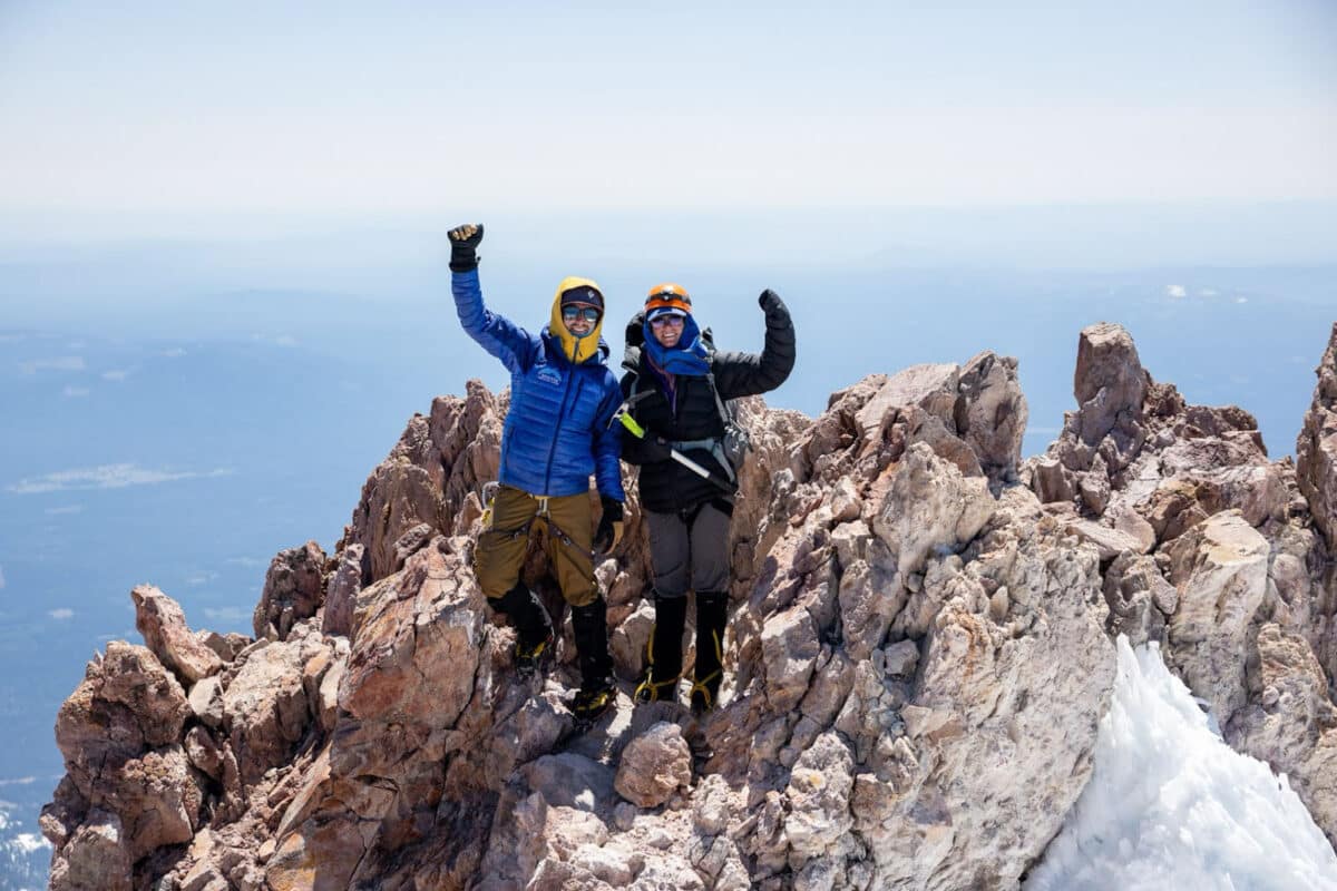 Alameda Post - two hikers stand at the summit of Mount Shasta