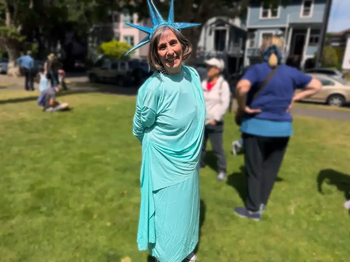 Alameda Post - a woman stands in a statue of liberty costume