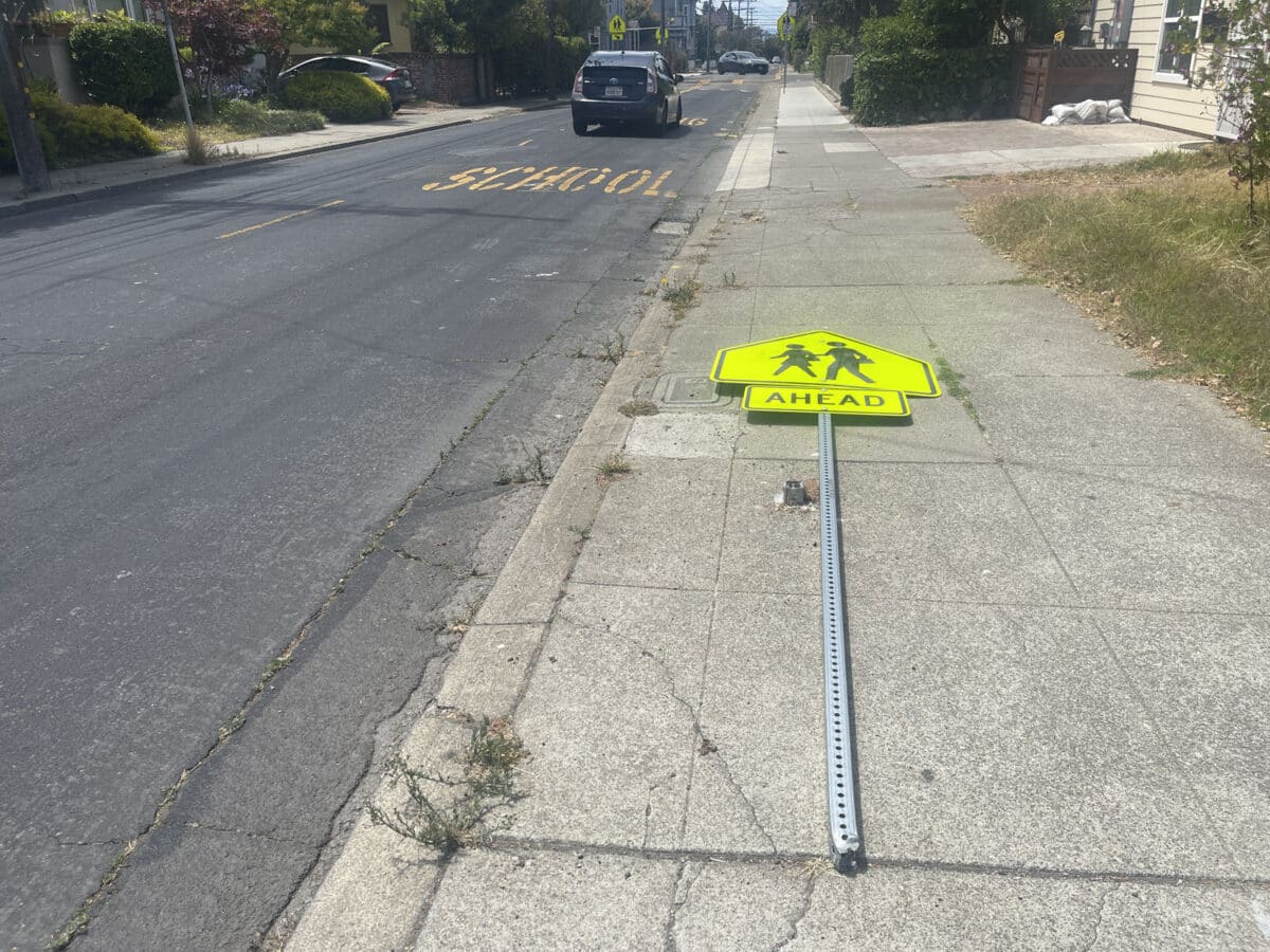 Alameda Post - a crosswalk ahead street sign laying on the ground