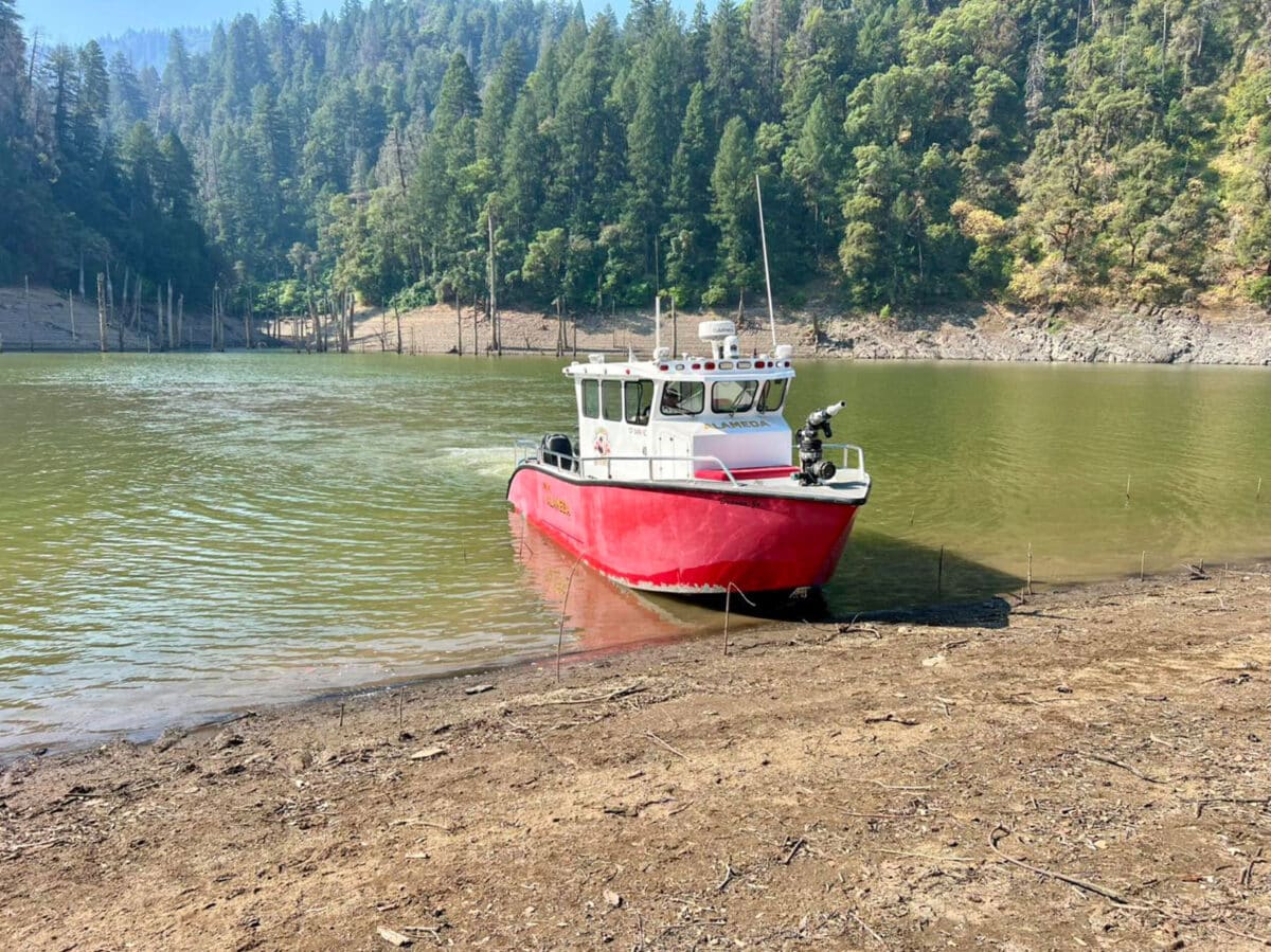 Alameda Post - A fire boat on the shore of a lake