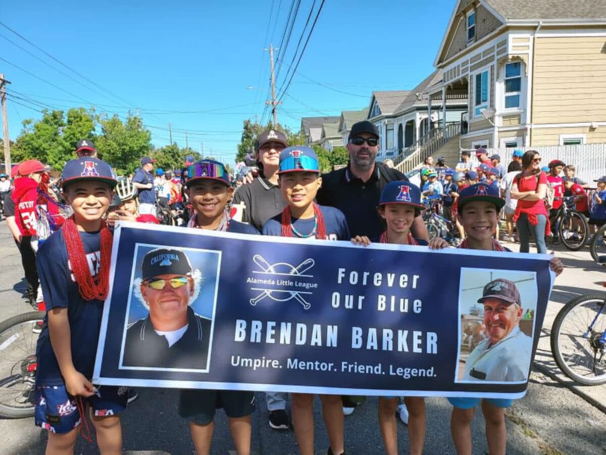 Alameda Post - Little Leaguers hold a banner commemorating Brendan Barker in the 2025 4th of July Parade.