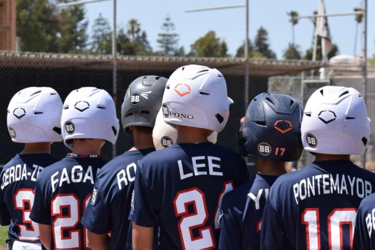 Alameda Post - Little League baseball players with 'BB' stickers on their helmets in memory of Brendan Barker