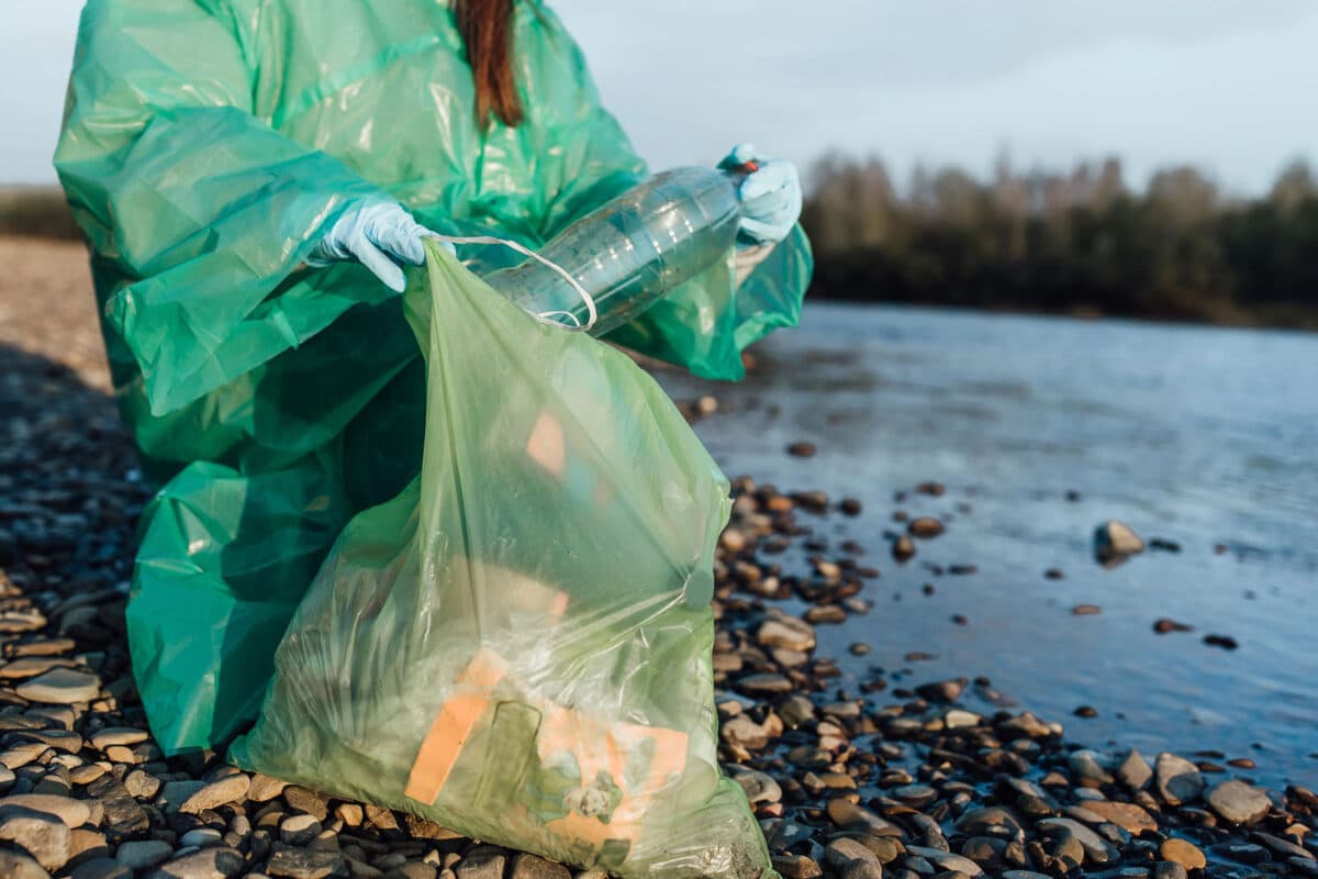 Alameda Post - someone cleans up plastic on the beach