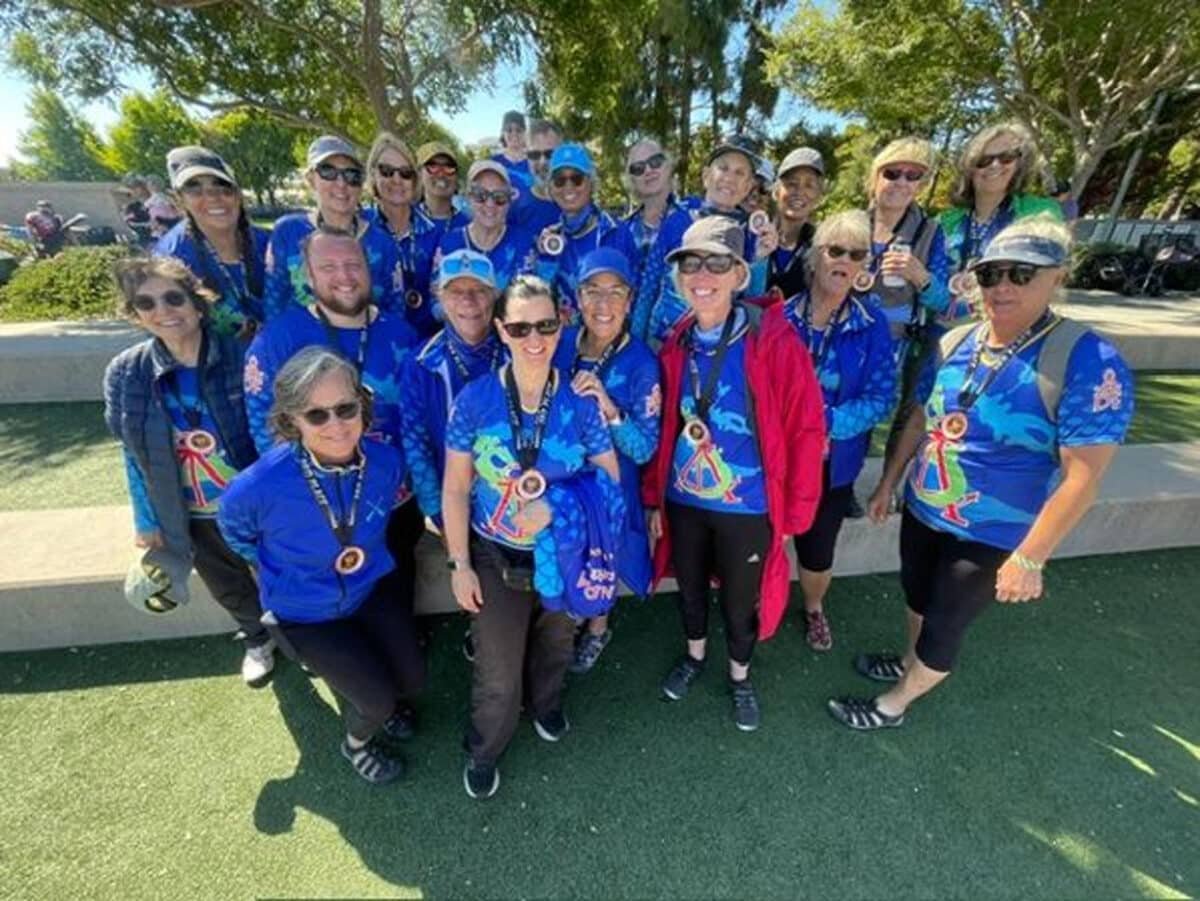Alameda Post - a group photo of the DragonFlyers team wearing uniforms and medals around their necks