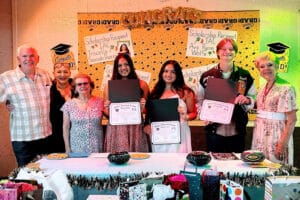 Alameda Post - scholarship winners of the Italian American League of Alameda smile and hold certificates surrounded by adults