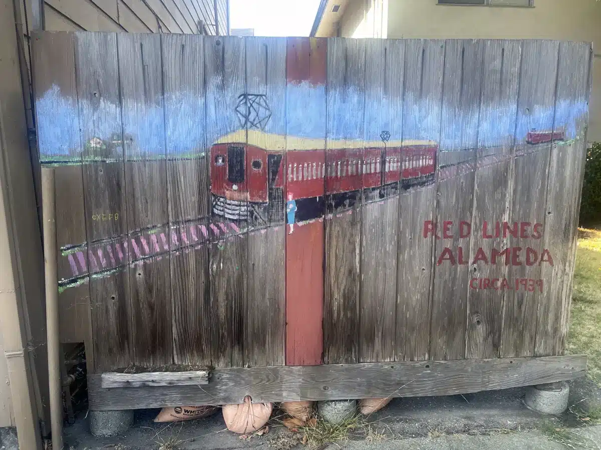 Alameda Post - Artwork of a train car on a fence