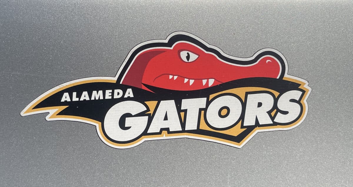 Alameda Post - the logo of the Alameda Gators which appears to be on a magnet on the shiny paint of a car