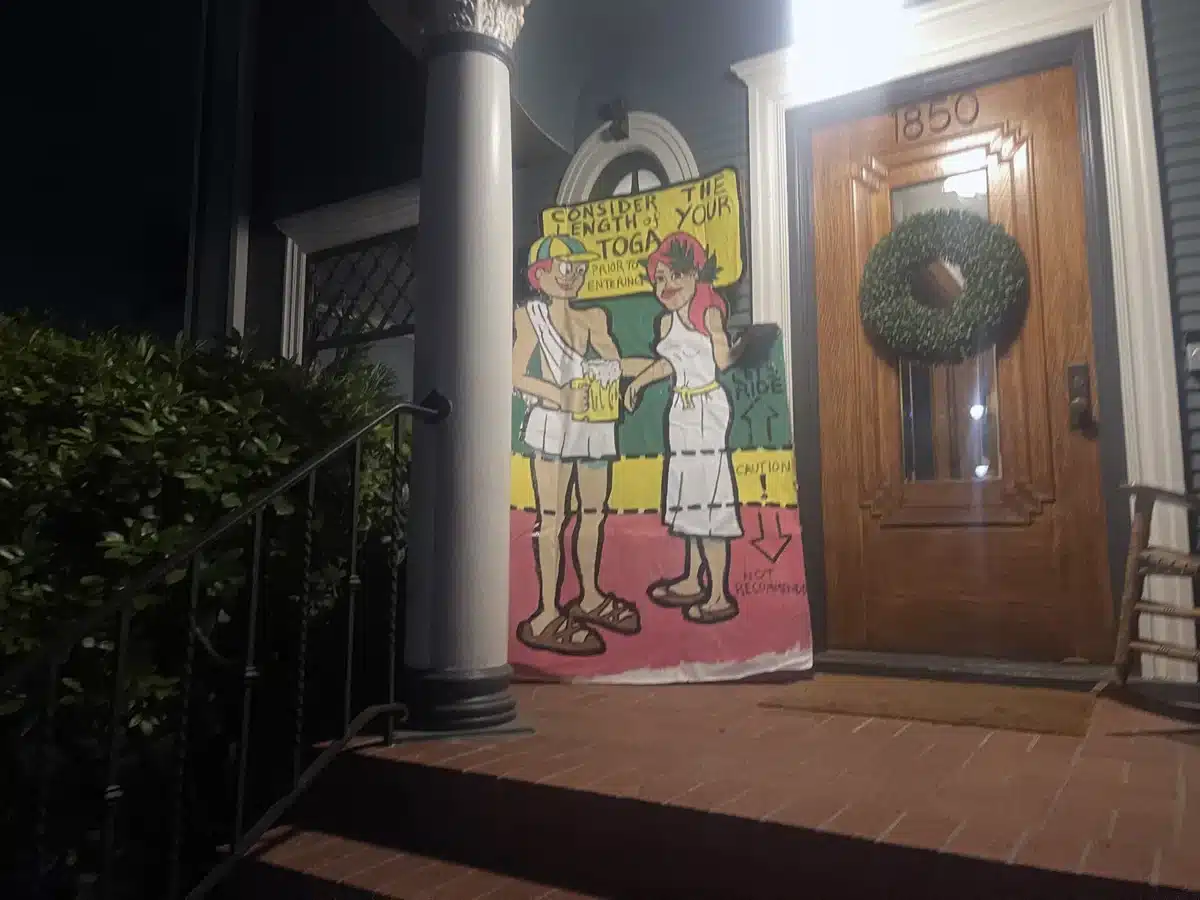Alameda Post - a sign on a porch announcing a toga party