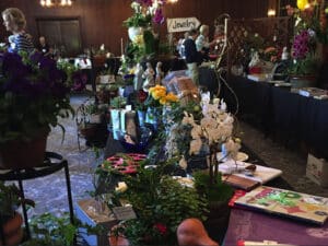 Alameda Post - a lovely room filled with decor, plants, and other items for sale at the AWC's Summer Faire