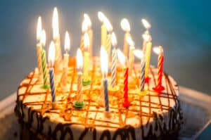 Alameda Post - a birthday cake with lit candles