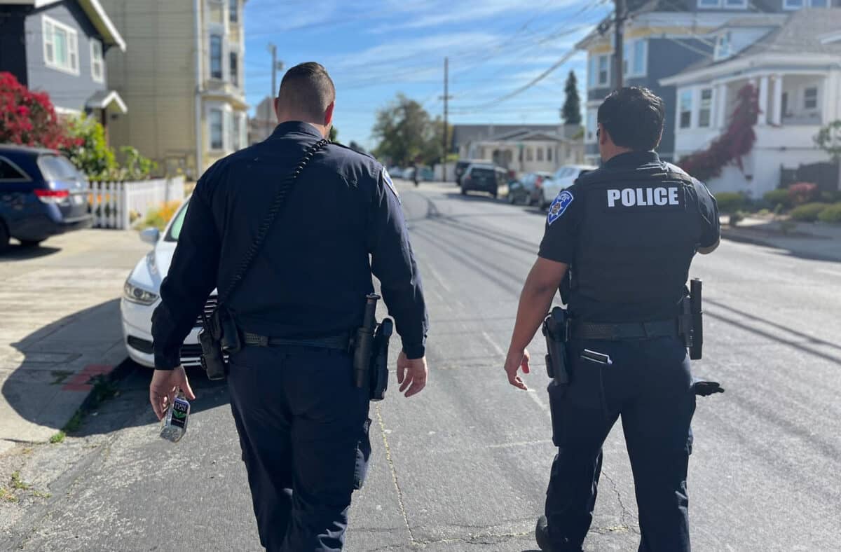Alameda Post - two police officers walk along a street