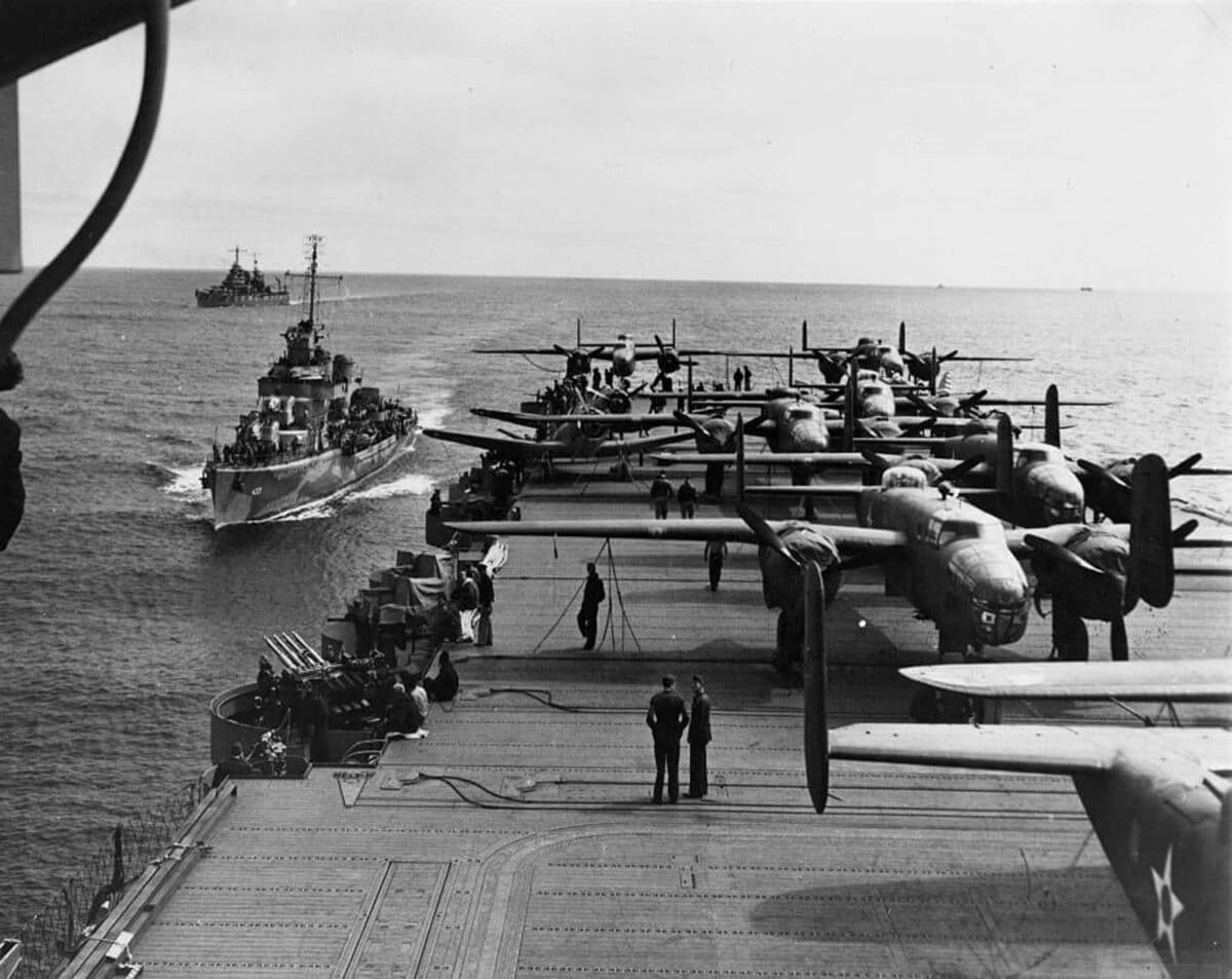 Alameda Post - a black and white photo of the USS Hornet with a lot of planes on top of it