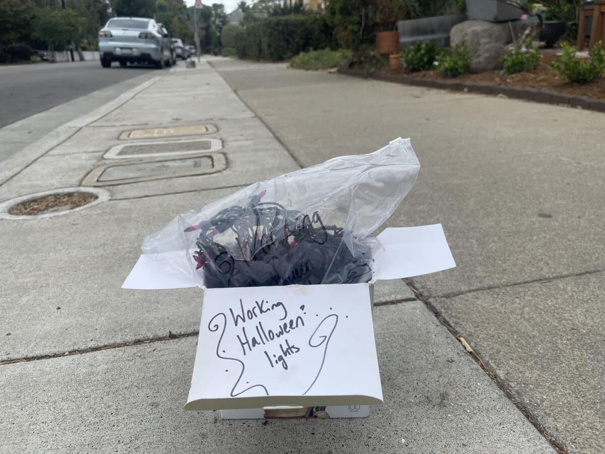 Alameda Post - a box of string lights with a note written "Working Halloween lights" on the side. It's sitting on the sidewalk for somebody to take