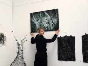 Alameda Post - Anita Sulimanovic hangs artwork.