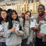 Alameda Post - Five AHS students in the AguaEmpowers club smile and hold kits they have assembled.
