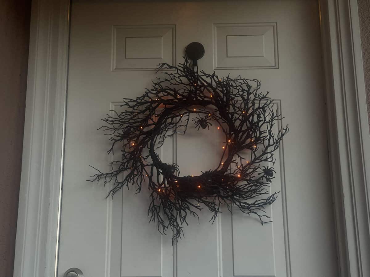 Alameda Post - A wreath on a front door make of spooky twigs and orange lights.