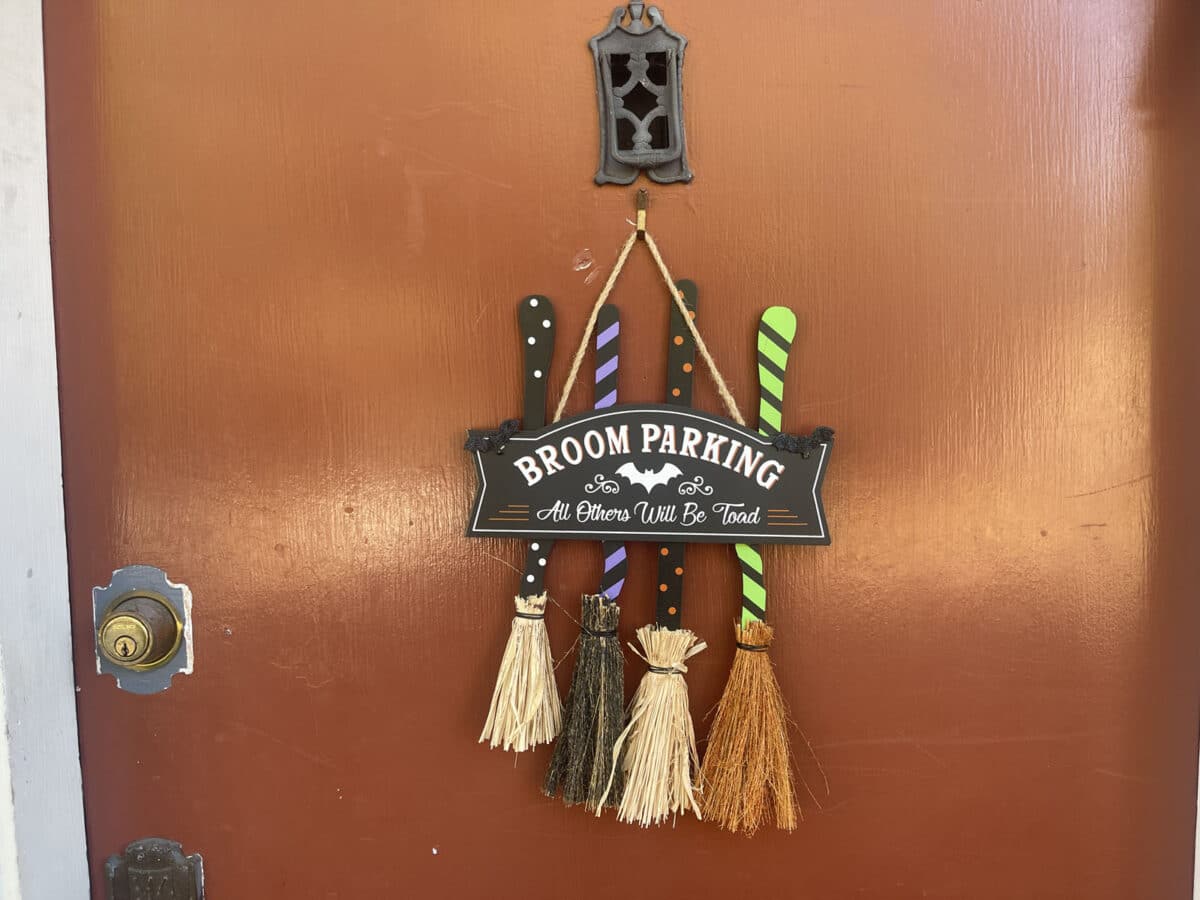 Alameda Post - A door hanging decoration that says "Broom Barking" with small decorative brooms on it.