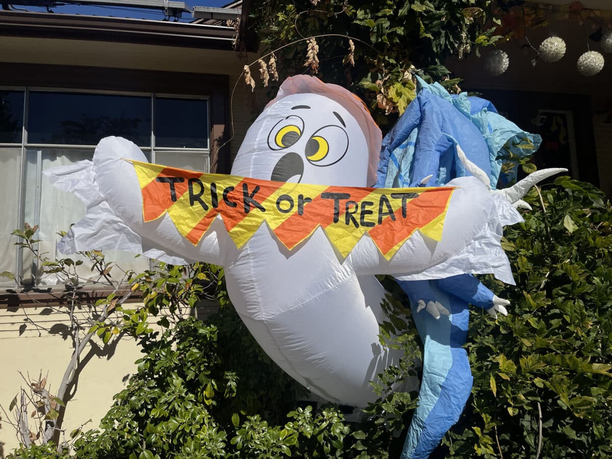 Alameda Post - Halloween decor in a yard. It's a surprised looking ghost with a banner that says Trick or Treat.