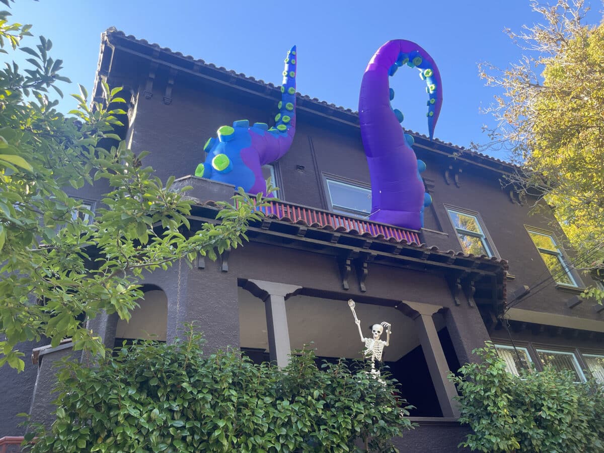 Alameda Post - Large blow up tentacles on the second floor of a large home. The decor gives the appearance of a huge sea monster that is overtaking the inside of the home.