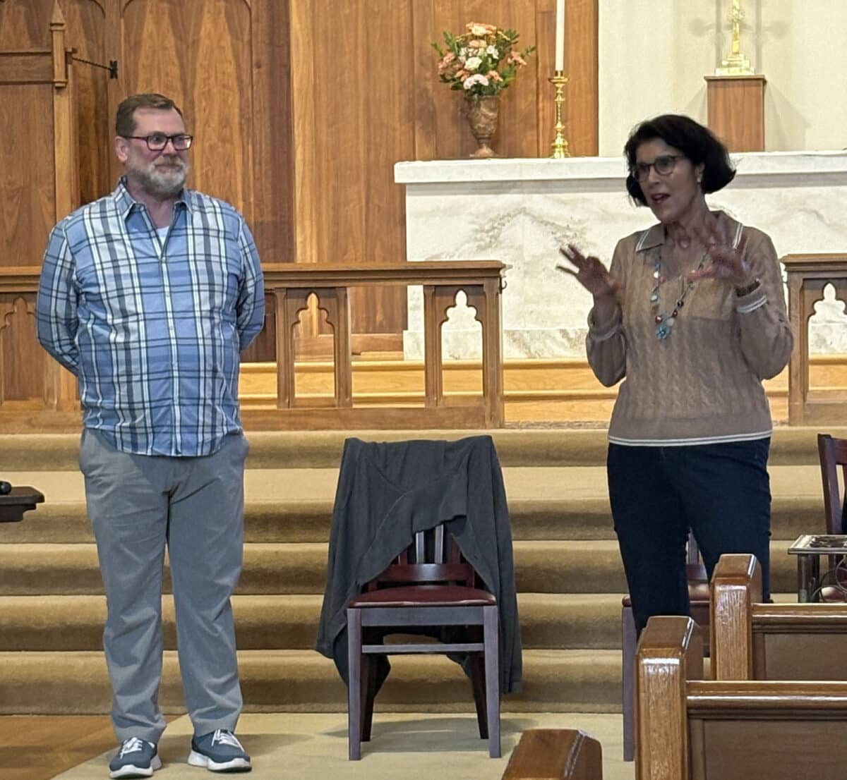 Alameda Post - A man and woman stand at the front of Christ Episcopal Church and talk.