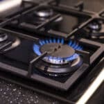 Alameda Post - A gas stove burner that is lit.