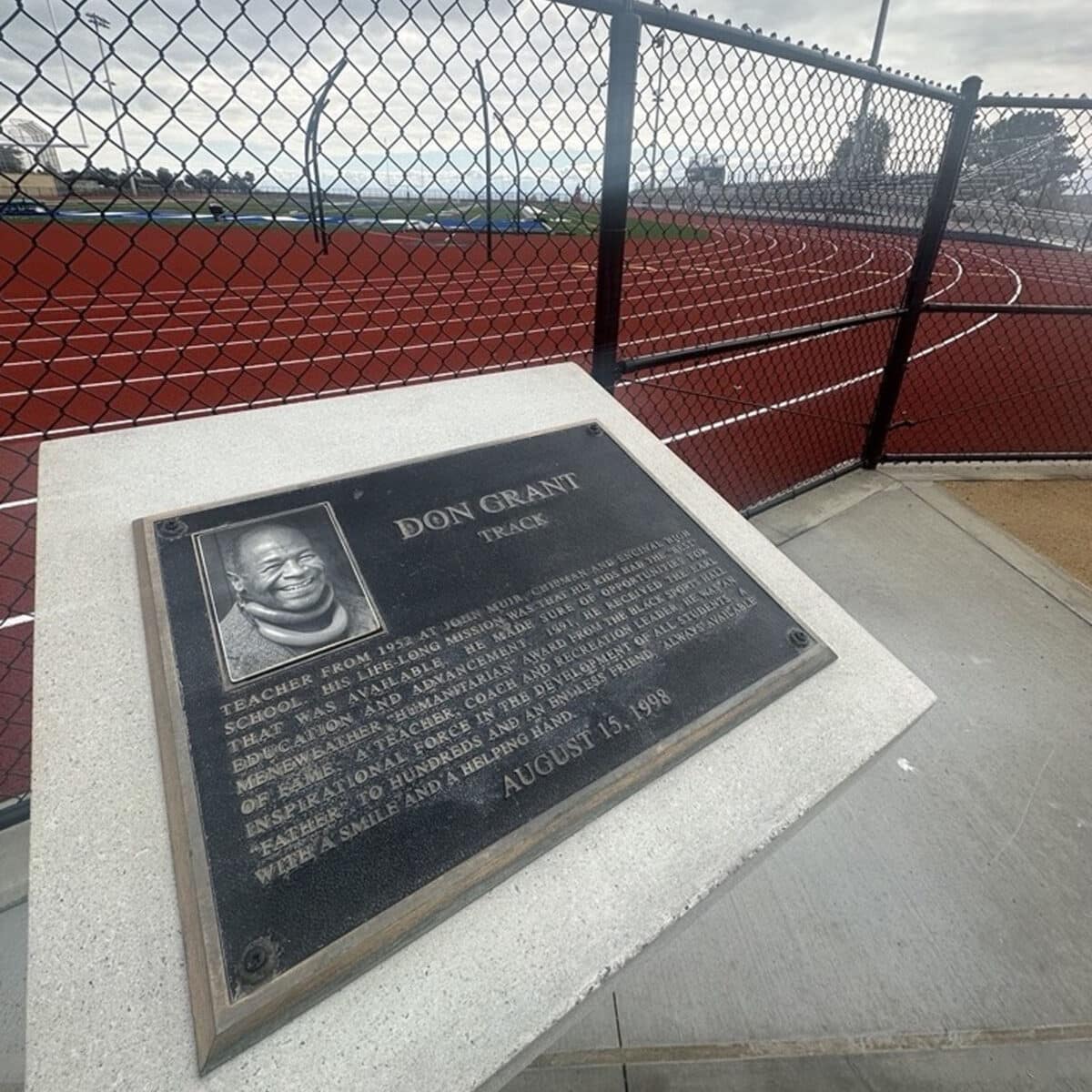 Alameda Post - A plaque honoring Don Grant next to a running track.
