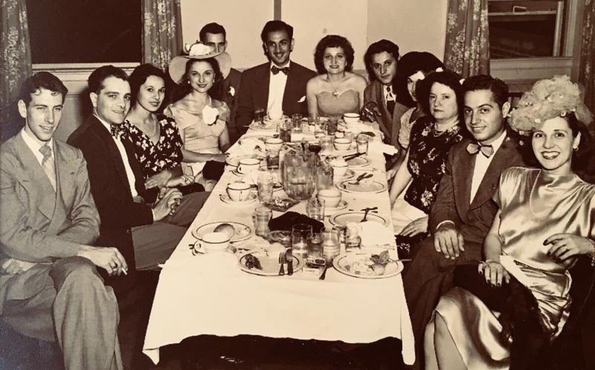 Alameda Post - A black and white photo of a large family or group around a dinner table