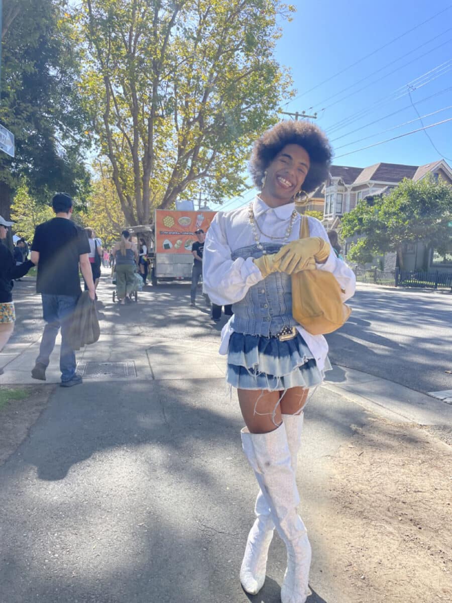 Alameda Post - An Alameda Pride attendee wearing a cute white and denim outfit smiles for the camera. 