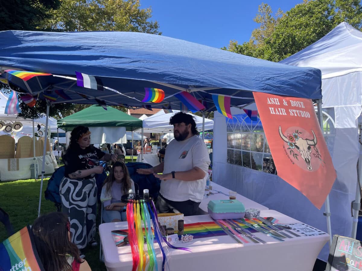 Alameda Post - A booth at Alameda Pride in the Park where attendees can get rainbow colors in their hair.