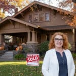 Alameda Post - Realtor® Liz Rush stands in front of a home with a sold sign on the lawn.