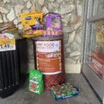 Alameda Post - An overflowing donation barrel for pet food outside of Grocery Outlet.