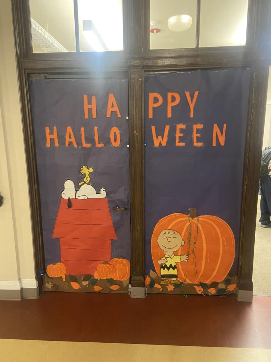 Alameda Post - A beautifully decorated doorway in a school. Carefully placed colored paper, cutouts, and paint create a scene of Charlie Brown next to Snoopy and Woodstock. 