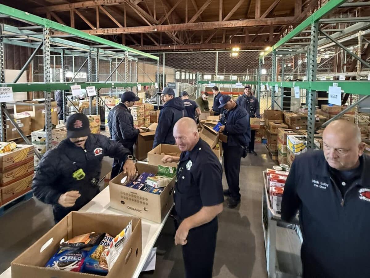 Alameda Post - AFD personnel box goods at the Alameda Food Bank.
