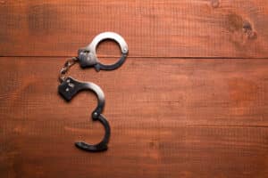 Alameda Post - A pair of open handcuffs of a table.