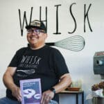 Alameda Post - Henry Awayan smiles at Whisk Bakery and holds his book, The Ube Baking Book.
